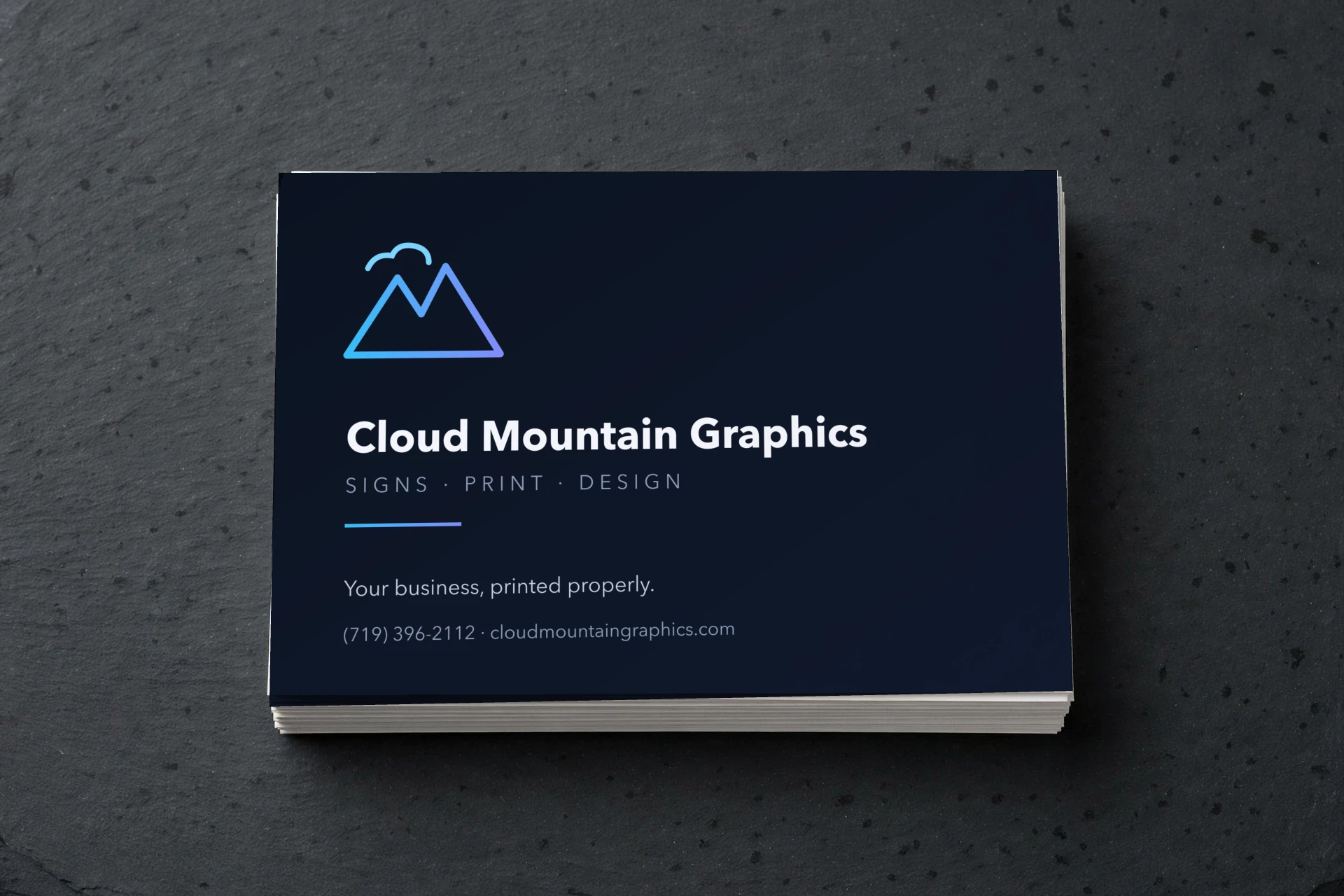 Postcard with the dark Cloud Mountain design on top of a stack, on dark slate