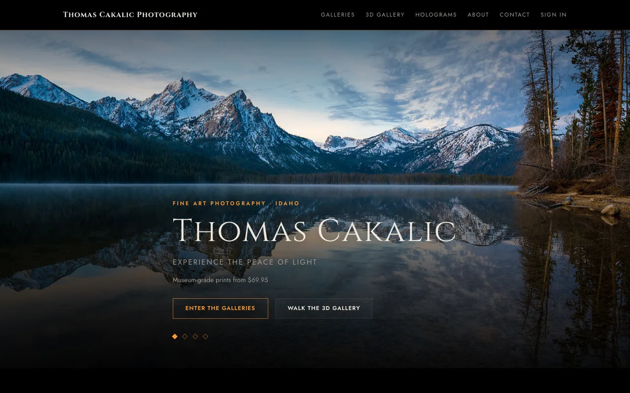 Thomas Cakalic Photography’s live homepage: snowy peaks reflected in a still mountain lake